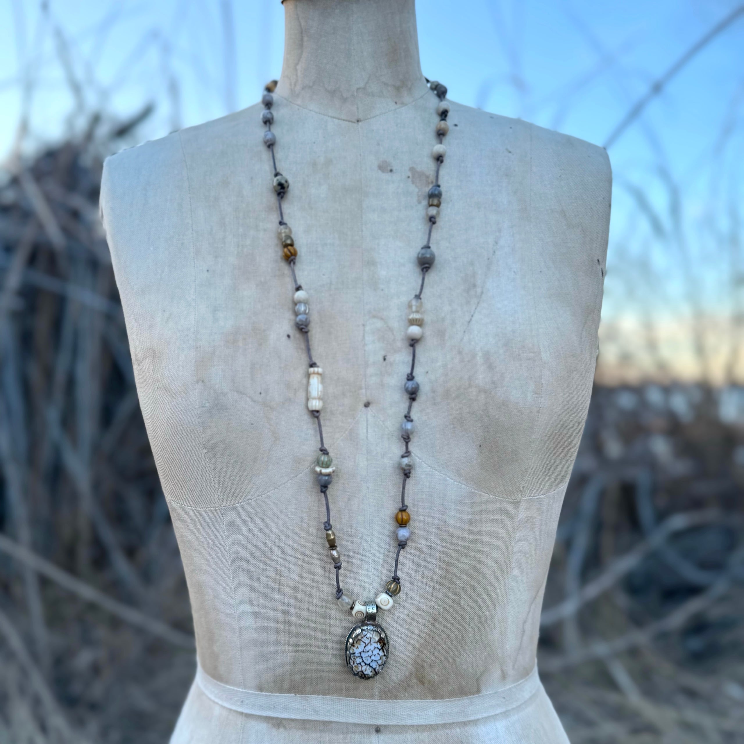 Jasper, goldstone, and store sterling silver necklace, with leather and lampwork bead accents.